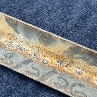Sale Photo Thumbnail #504: Vintage metal tool or component channel showing heavy rust, corrosion, and stenciled numbers.