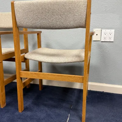 Sale Photo Thumbnail #694: Mid-century modern oak armchairs with beige woven upholstery.