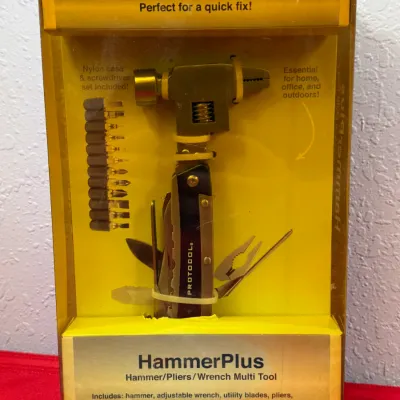 Sale Photo Thumbnail #535: Protocol HammerPlus multi-tool set in original yellow blister packaging, featuring a combined hammer, adjustable wrench, pliers, and screwdriver bits.