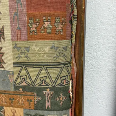 Sale Photo Thumbnail #306: Framed Southwestern style woven tapestry featuring tribal figures, geometric shapes, and animal motifs.