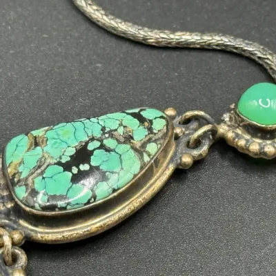 Sale Photo Thumbnail #327: Vintage sterling silver necklace featuring bezel-set turquoise matrix and green chalcedony cabochons linked on a woven chain.