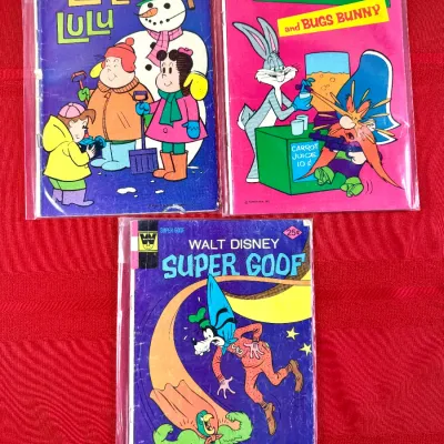 Sale Photo Thumbnail #810: Trio of vintage Whitman comic books from the 1970s, including Little Lulu, Yosemite Sam and Bugs Bunny, and Walt Disney Super Goof, each individually bagged.