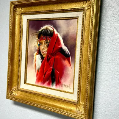 Sale Photo Thumbnail #151: Framed Western oil painting on canvas depicting a Native American figure wrapped in a red blanket, signed Hoebel in the lower right, set in an ornate gilded frame with a canvas liner.