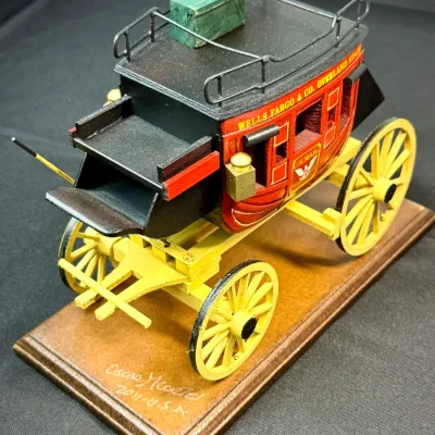 Sale Photo Thumbnail #493: Handcrafted miniature Wells Fargo & Co. Overland Stage stagecoach model on a wooden base, signed and dated 2011.