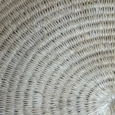 Sale Photo Thumbnail #387: Close-up detail of a tightly woven spiral straw or natural fiber tray or basket, showing intricate radial craftsmanship.