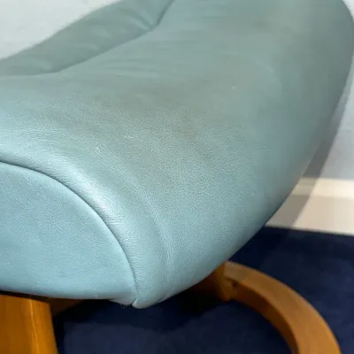 Sale Photo Thumbnail #240: Ekornes Stressless ottoman with light teal-blue leather upholstery and a bentwood base.