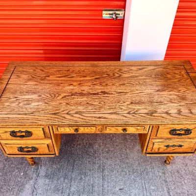 Sale Photo Thumbnail #257: Vintage oak executive desk featuring a inlaid wood top border, ornamental metal bale handles, and spiral turned legs.