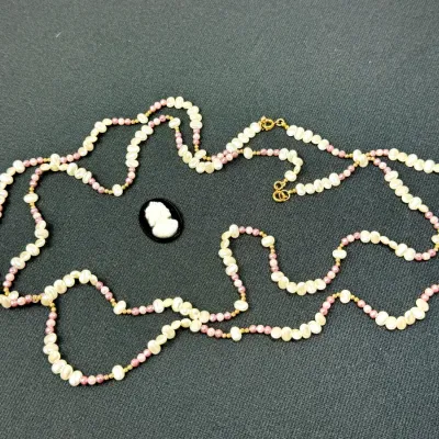 Sale Photo Thumbnail #9: Strand of freshwater pearls with pink accent beads paired with a small black and white cameo pendant.