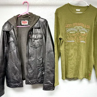 Sale Photo Thumbnail #94: Men's Levi's faux-leather hooded jacket with zip closure alongside a green thermal long-sleeve Levi Strauss & Co. graphic shirt.