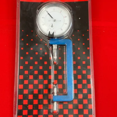 Sale Photo Thumbnail #534: Engine Building Tools brand rod bolt stretch gauge with a 0.001-inch dial indicator, sealed in its original clamshell packaging.