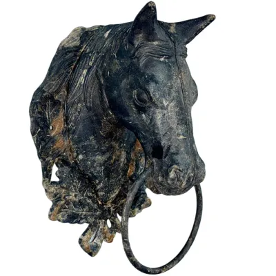 Sale Photo Thumbnail #58: Vintage cast iron horse head hitching post topper with a nose ring, featuring heavy patina and wear consistent with outdoor use.