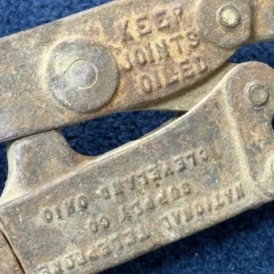 Sale Photo Thumbnail #569: Vintage National Telephone Supply Co. heavy-duty metal crimping or splicing tool featuring embossed lettering and surface rust.
