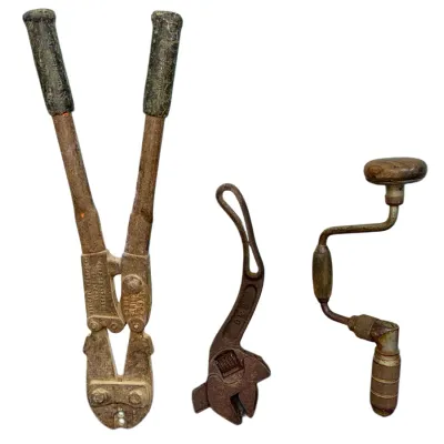 Sale Photo Thumbnail #47: Collection of three vintage hand tools including a heavy-duty Nicopress swaging tool, a curved adjustable wrench, and a hand brace drill.