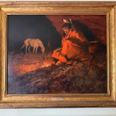 Sale Photo Thumbnail #102: Framed oil painting titled "The Trade Blanket" by William Moyers, depicting a Native American figure wrapped in a red blanket beside a campfire with a horse in the background.