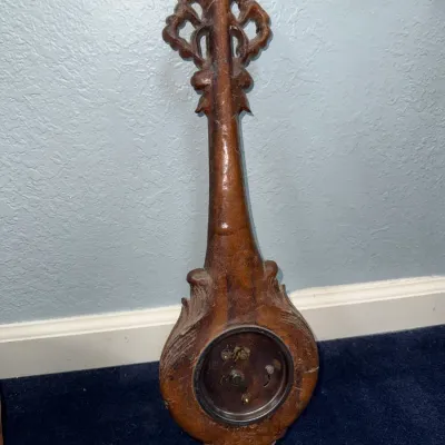 Sale Photo Thumbnail #397: Vintage carved wooden banjo wall barometer or clock housing with intricate scrolling crest detail, shown from the back.