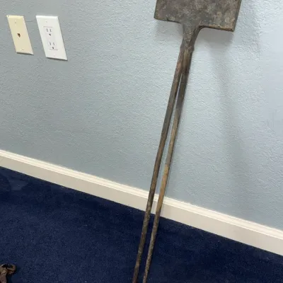 Sale Photo Thumbnail #579: Antique wrought iron blacksmith waffle iron or wafer press featuring long handles and a rectangular paddle, showing heavy patina and rust.