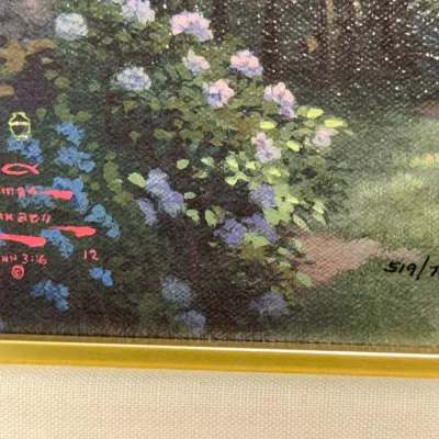 Sale Photo Thumbnail #825: Detail view of a Thomas Kinkade signed and numbered print, featuring the artist's red signature in the corner alongside the edition number 519/700 G/P.