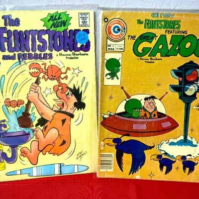 Sale Photo Thumbnail #786: Pair of Charlton Comics Flintstones comic books, including 'The Flintstones and Pebbles' No. 27 (1974) and 'The Great Gazoo' No. 15 (1976), both protected in plastic sleeves.
