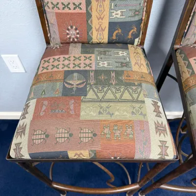 Sale Photo Thumbnail #305: High-top bar stool featuring a metal frame and Southwestern-style geometric tapestry upholstery with Kokopelli and animal motifs.