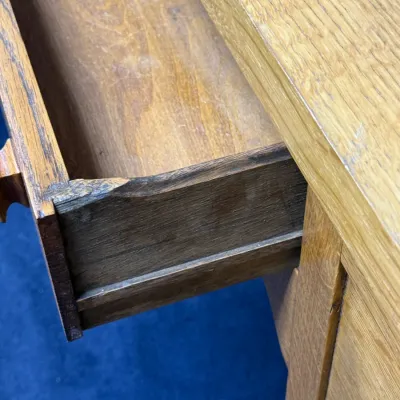 Sale Photo Thumbnail #686: Open wooden drawer showing the interior construction of an oak desk or cabinet.
