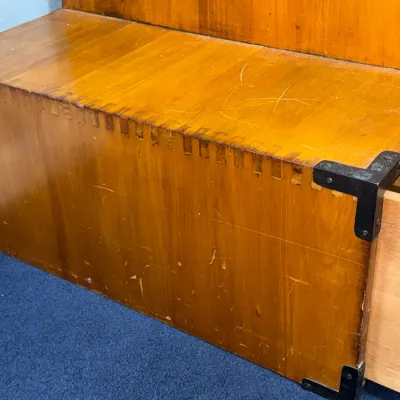 Sale Photo Thumbnail #215: Vintage campaign-style wooden chest with box-joint construction and black metal corner braces, showing visible surface scratches.