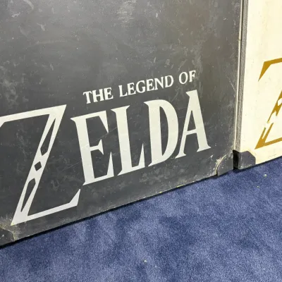 Sale Photo Thumbnail #924: Close-up of hardbound The Legend of Zelda box sets or strategy guides with metallic lettering, showing light surface wear.
