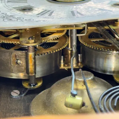 Sale Photo Thumbnail #378: Close-up view of the brass clock movement and chime mechanism inside a Seth Thomas clock.