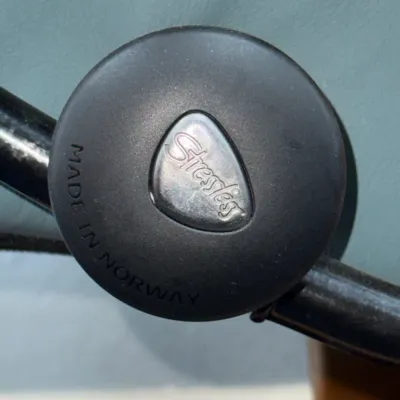 Sale Photo Thumbnail #233: Close-up of a Stressless by Ekornes recliner adjustment knob, stamped "Made in Norway."