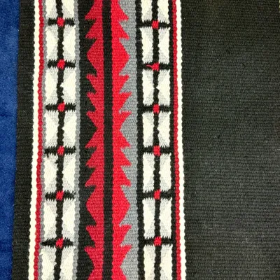 Sale Photo Thumbnail #437: Southwestern-style hand-woven wool textile or saddle blanket featuring geometric patterns in red, grey, white, and black.