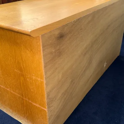 Sale Photo Thumbnail #722: Back and side view of a light oak or laminate credenza showing minor surface wear.