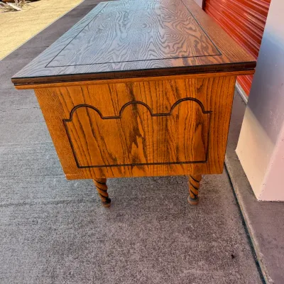 Sale Photo Thumbnail #263: Vintage oak coffee table featuring a dark inlay accent on top, carved side paneling, and barley twist legs.