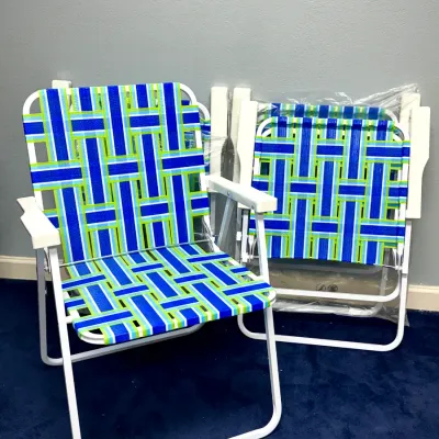 Sale Photo Thumbnail #915: Set of folding lawn chairs featuring white aluminum frames and woven blue, green, and white webbed seats.