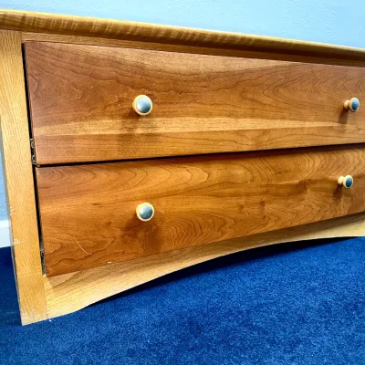 Sale Photo Thumbnail #715: Two-drawer solid wood chest featuring contrasting oak and cherry finish wood tones and round metal-accented knobs.