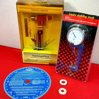 Sale Photo Thumbnail #533: Selection of specialty hand and engine building tools, including a HammerPlus multi-tool set in box, a rod bolt stretch gauge with dial indicator in blister pack, and a blue degree wheel for engine timing.