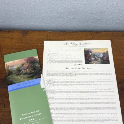 Sale Photo Thumbnail #819: Thomas Kinkade Collectors' Society 2003 application brochure alongside a Thomas Kinkade "The Village Lighthouse" statement of editions document.