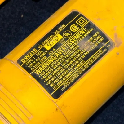 Sale Photo Thumbnail #602: DeWalt DW318 Type 1 variable-speed orbital jig saw showing model and safety information label.