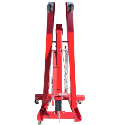 Sale Photo Thumbnail #41: Foldable red hydraulic engine hoist with swivel caster wheels and attached chain assembly.