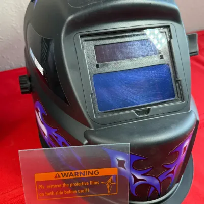 Sale Photo Thumbnail #517: Chicago Electric Systems auto-darkening welding helmet featuring blue and purple flame graphics. Includes an extra clear protective lens cover.