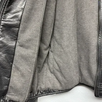 Sale Photo Thumbnail #882: Interior view of a black leather jacket featuring a removable heather grey zip-out lining.