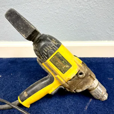 Sale Photo Thumbnail #612: DeWalt DW130V 1/2-inch spade handle VSR drill with cord, showing heavy signs of use and wear.