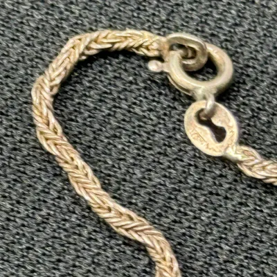 Sale Photo Thumbnail #182: Close-up of a sterling silver wheat chain necklace featuring a spring ring clasp.