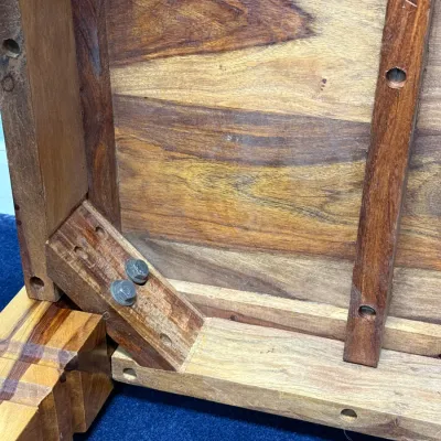 Sale Photo Thumbnail #740: Underside construction view of a solid wood table featuring corner brace assembly and visible grain patterns.