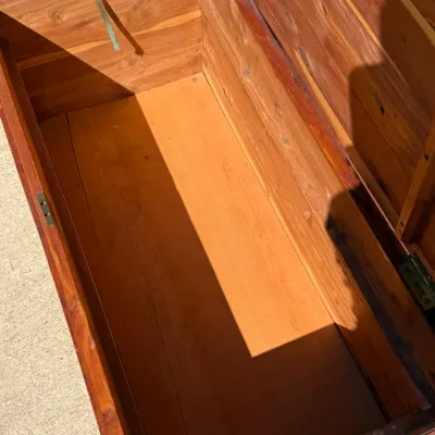 Sale Photo Thumbnail #322: Interior view of an open cedar storage chest, showing clean aromatic wood lining and original metal hardware.