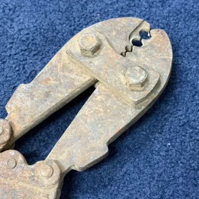 Sale Photo Thumbnail #570: Vintage heavy-duty wire crimping or cutting tool showing significant surface rust and wear.