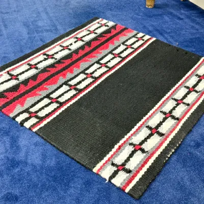 Sale Photo Thumbnail #440: Southwestern hand-woven wool saddle blanket or rug featuring bold geometric patterns in red, black, grey, and white, shown in good condition.