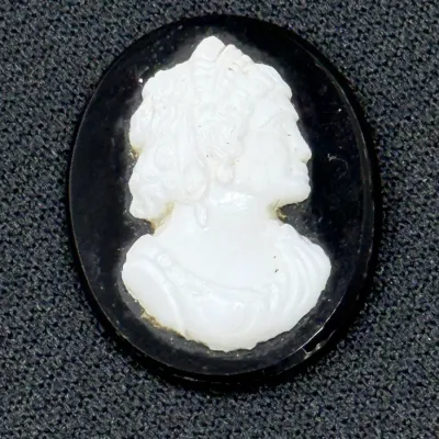 Sale Photo Thumbnail #192: Oval black and white cameo cabochon featuring a detailed classical profile portrait, suitable for jewelry making or setting.