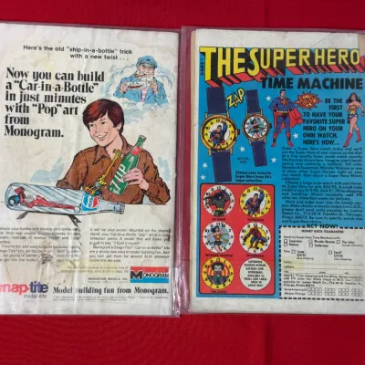 Sale Photo Thumbnail #774: Pair of vintage comic books in protective plastic sleeves showing full-page advertisements on their back covers.