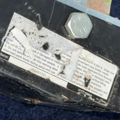 Sale Photo Thumbnail #660: Close-up detail of a serial number and warning label on piece of heavy equipment, showing item number 69855 and serial number 352401721.