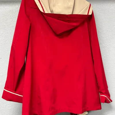 Sale Photo Thumbnail #897: Bright red hooded jacket featuring beige contrast lining, striped trim accents, and rolled cuffs.