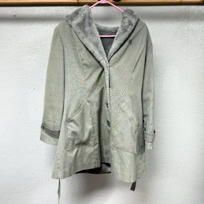 Sale Photo Thumbnail #93: Vintage women's sage green winter coat featuring a faux fur lining and collar, button closure, front pockets, and sleeve cuff details.